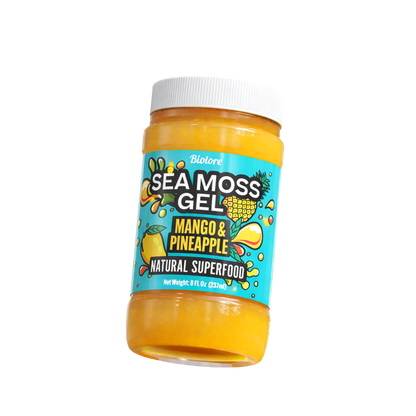 Bottle of sea moss gel with mango and pineapple flavor on a white background