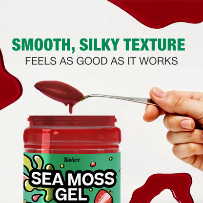 Spoon with strawberry sea moss gel showing smooth silky texture above an open jar.